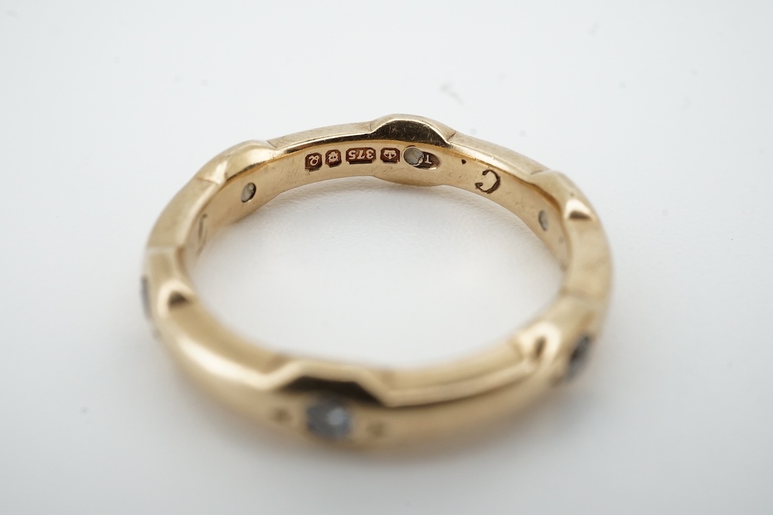 A modern 9ct gold and claw set single stone diamond ring, with four stone diamond chip set shoulders, size N, total carat weight approximately 0.20ct and a similar 9ct gold and six stone diamond set band, size K, gross w